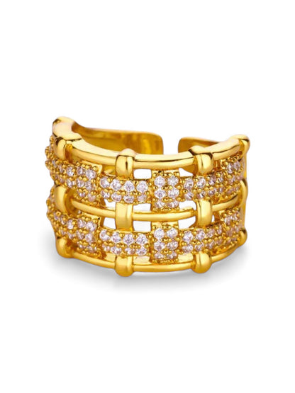 Gold ring with diamond accents on a white background