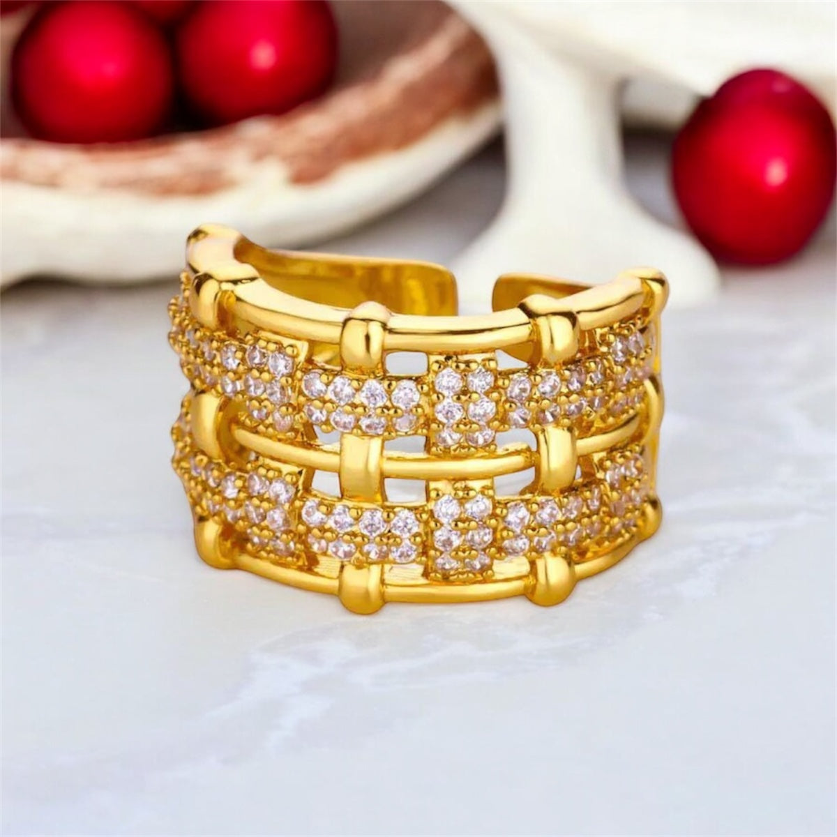 Gold bracelet with diamond accents on a light background
