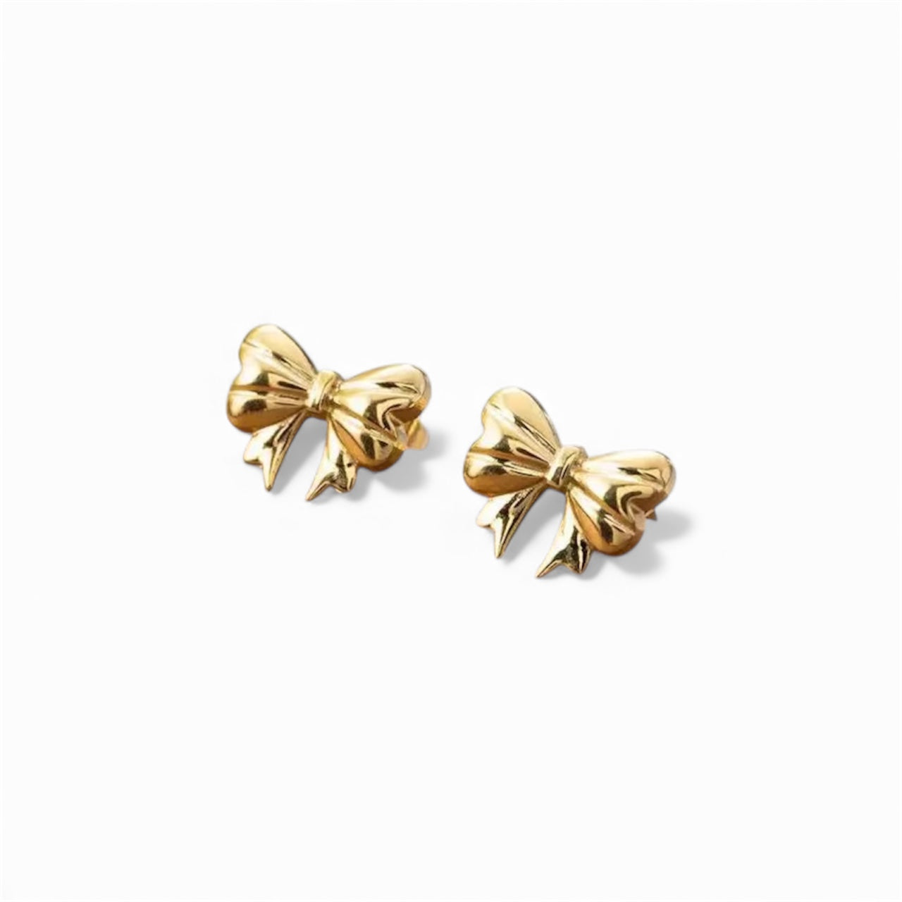 Gold bow-shaped earrings on a white background