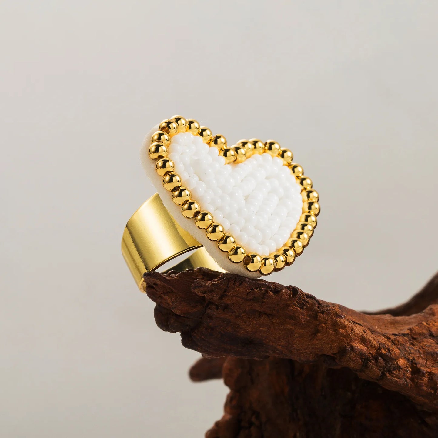 Heart-shaped object with gold border and white center