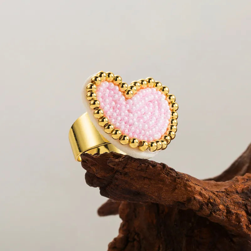 Gold ring with a pink heart-shaped bead