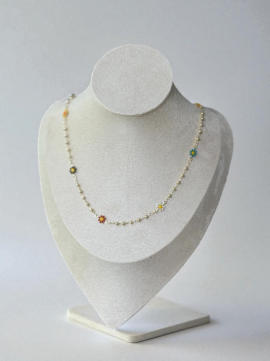 Necklace on a gray bust against a light gray background