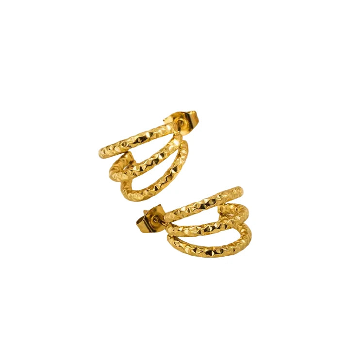 Gold hoop earrings on a white background