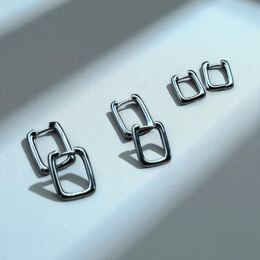 Pair of silver hoop earrings on a light gray background