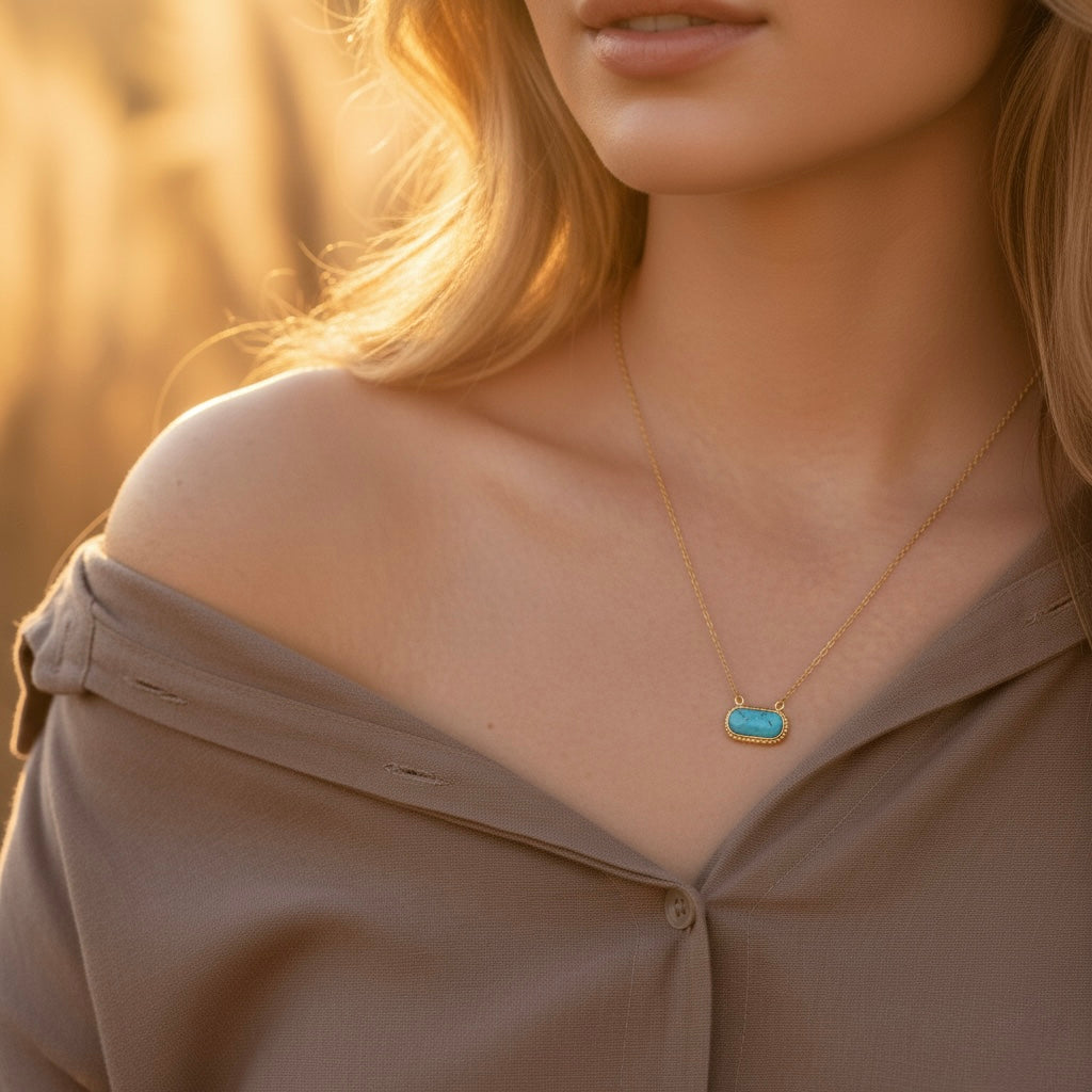 Woman wearing a necklace with a blue pendant against a blurred background