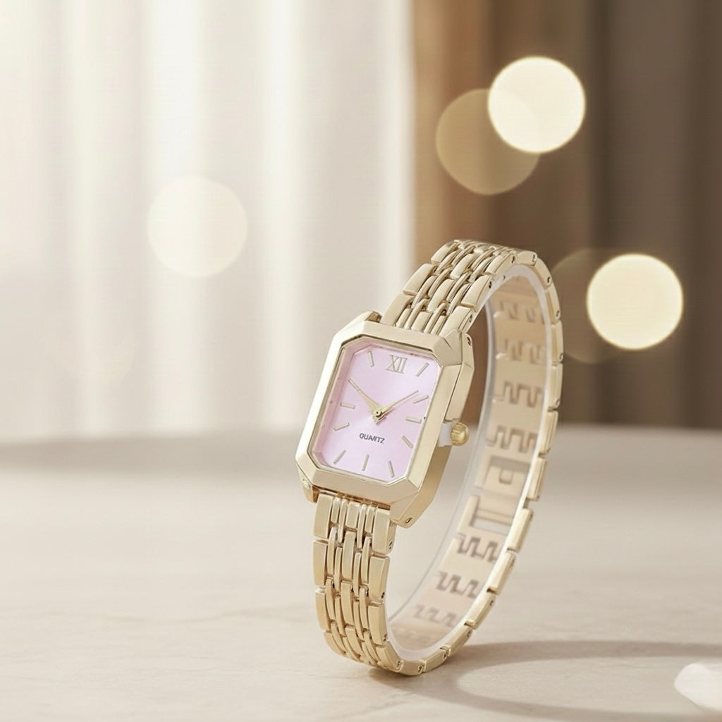 Gold wristwatch with a light face on a blurred background