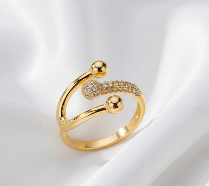 Gold ring with decorative elements on a white background