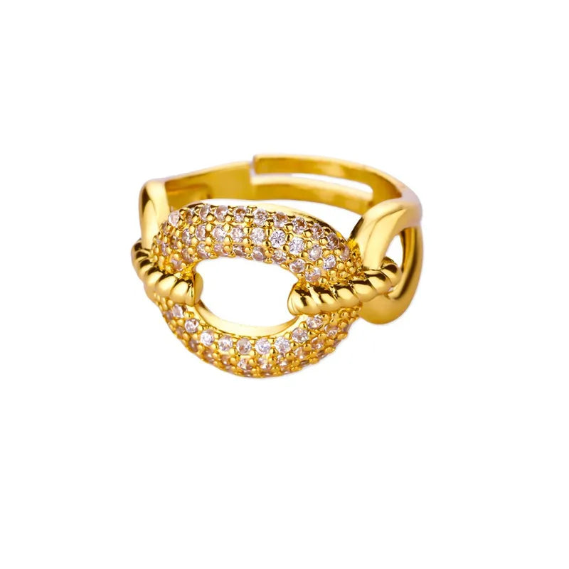 Gold ring with clear stones on a white background