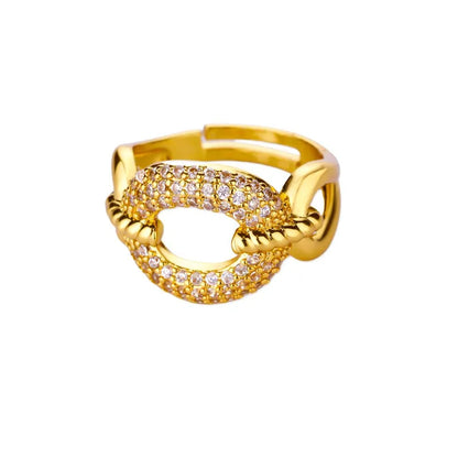 Gold ring with clear stones on a white background