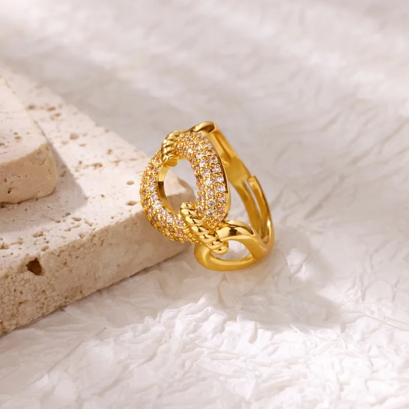 Gold ring with diamond accents on a textured white surface