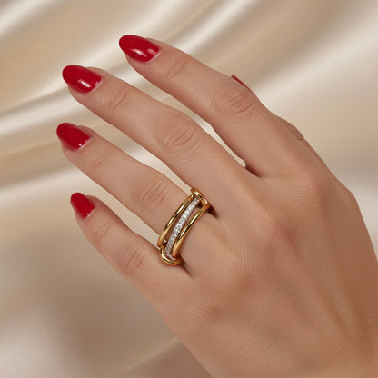 Hand wearing a gold ring with red nail polish on a beige background