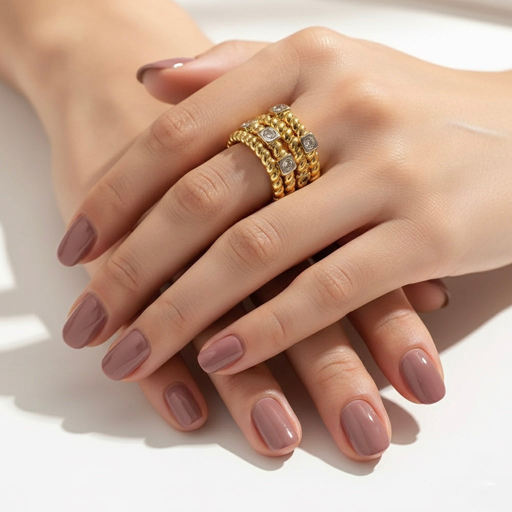 Close-up of a hand with a gold ring on a white background